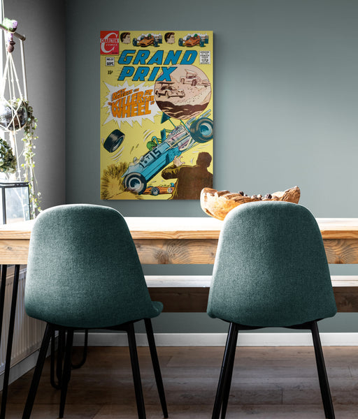 A large matte paper poster of the cover of the 1969 comic book "Grand Prix #27" next to a kitchen table with a wooden sculpture on it, bathed in afternoon light