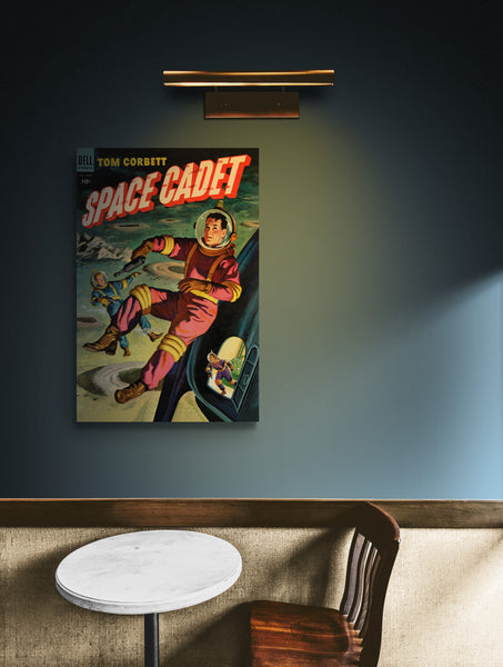 A large matte paper poster of the cover of the 1954 comic book "Space Cadet #9" hung above a small table and chair in a dim, warmly-lit cafe
