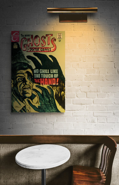 A large matte paper poster of the cover of the 1968 comic book "The Many Ghosts of Doctor Graves", in a quiet and dimly-lit cafe with a small table and wooden chair
