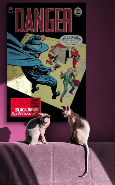 A large matte paper poster of the cover of the 1964 comic book "Danger #12", partially obscured by shadow, hung on a mauve wall with two Sphynx cats lounging in the sunbeam below