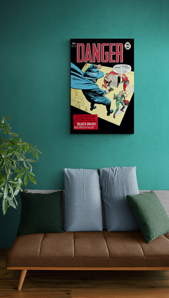 A large matte paper poster of the cover of the 1964 comic book "Danger #12" hung on a green wall with a retro sofa below.