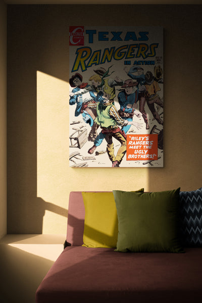 A large matte paper poster of the cover of the 1954 comic book "Texas Rangers #63", partially obscured by shadow, hung in the corner of a living room above a sofa with throw pillows