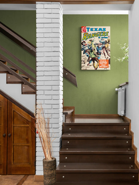 A large matte paper poster of the cover of the 1954 comic book "Texas Rangers #63" hung in the stairwell of a cozy home with dark wooden stairs